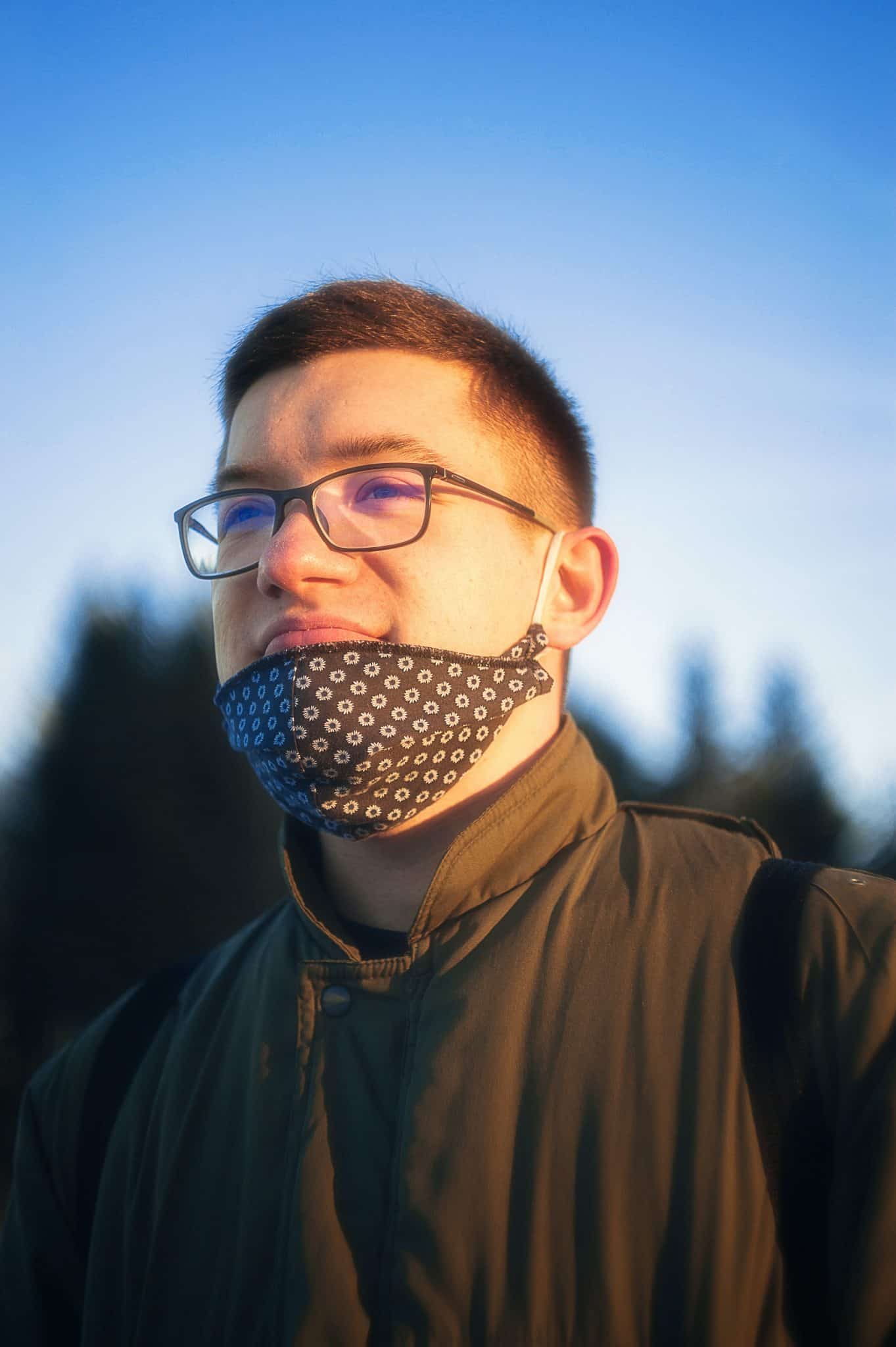 man in black jacket wearing black framed eyeglasses