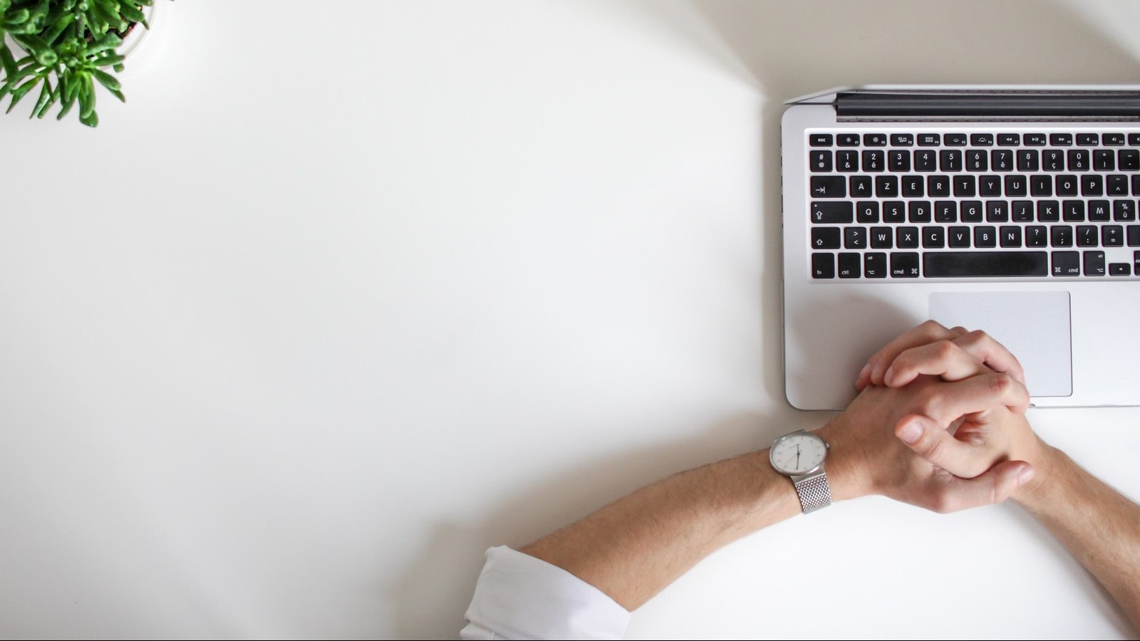 person wearing watch near laptop