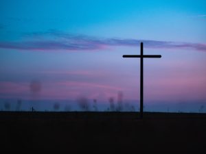 cross stand under purple and blue sky