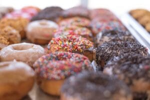 assorted doughnuts on brown wooden tray