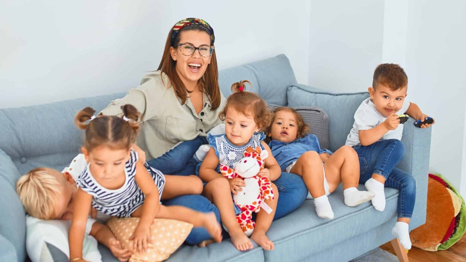 3 women sitting on gray couch