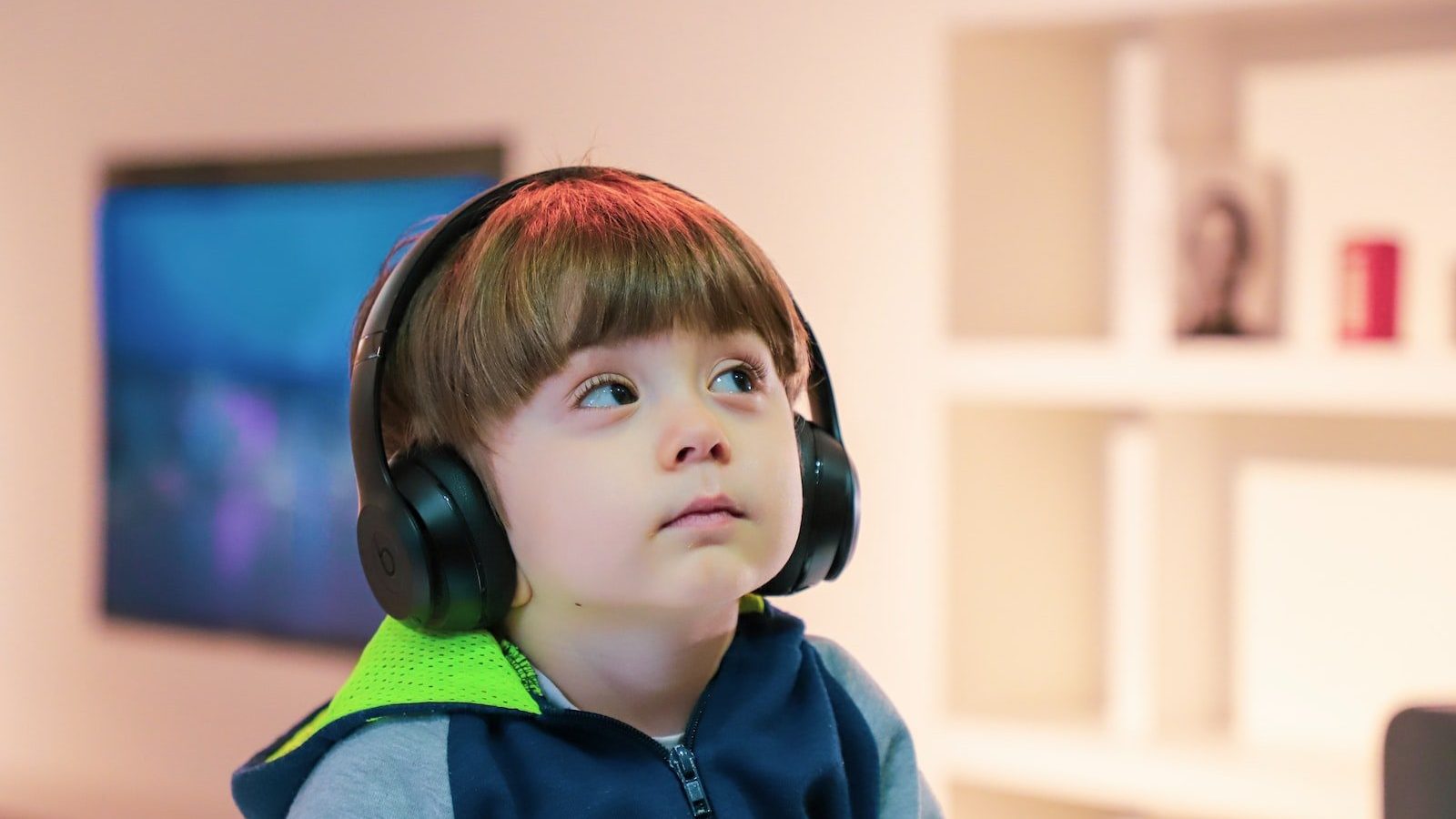 boy near white wooden shelf