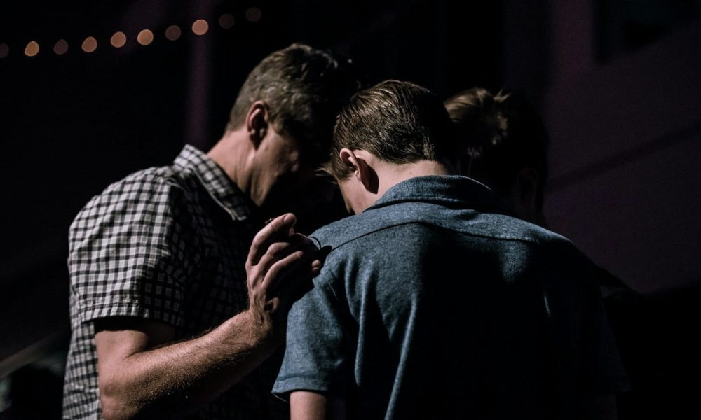 men touching each other's foreheads